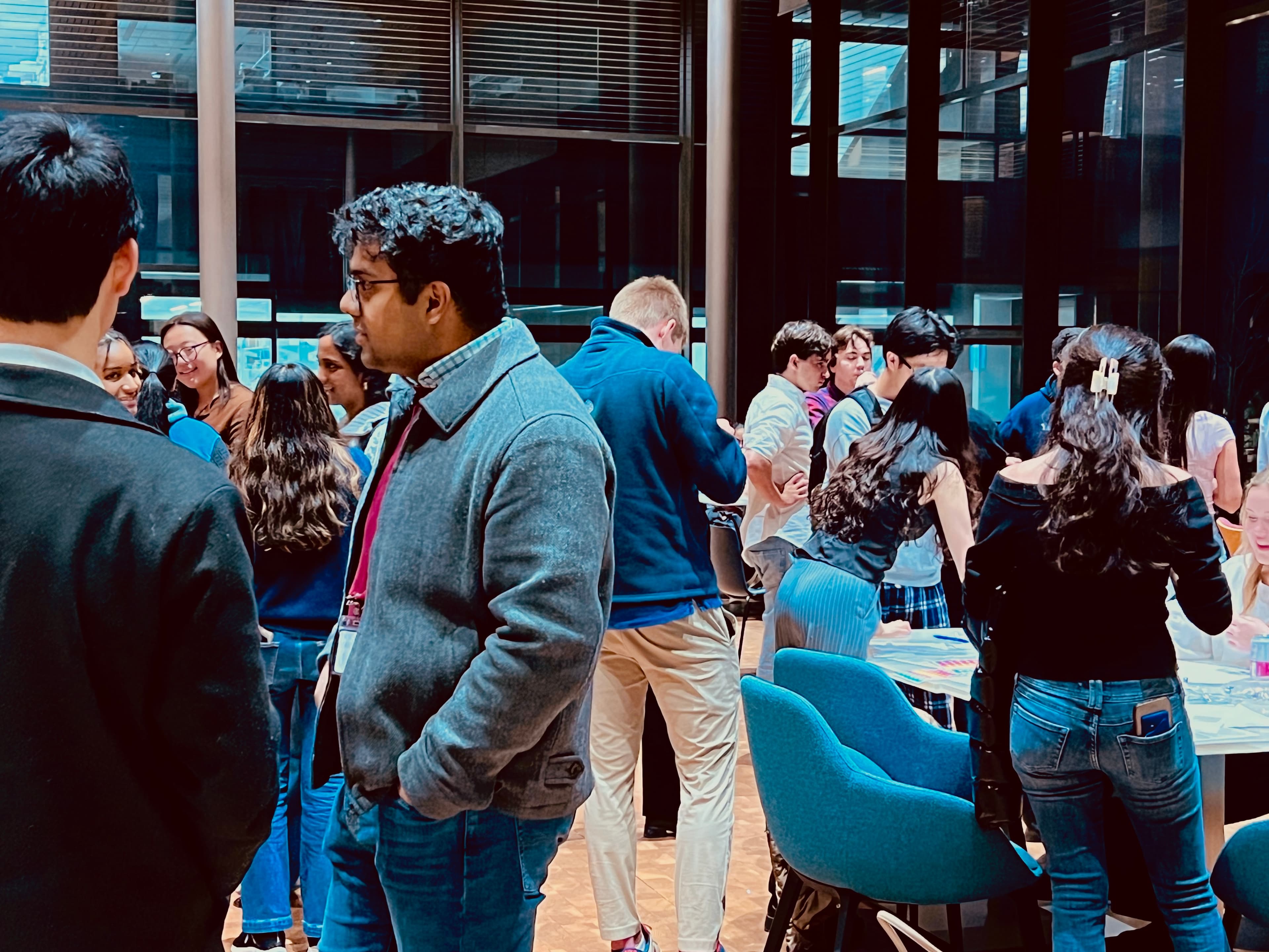 Event photo: attendees in conversation beside the tables
