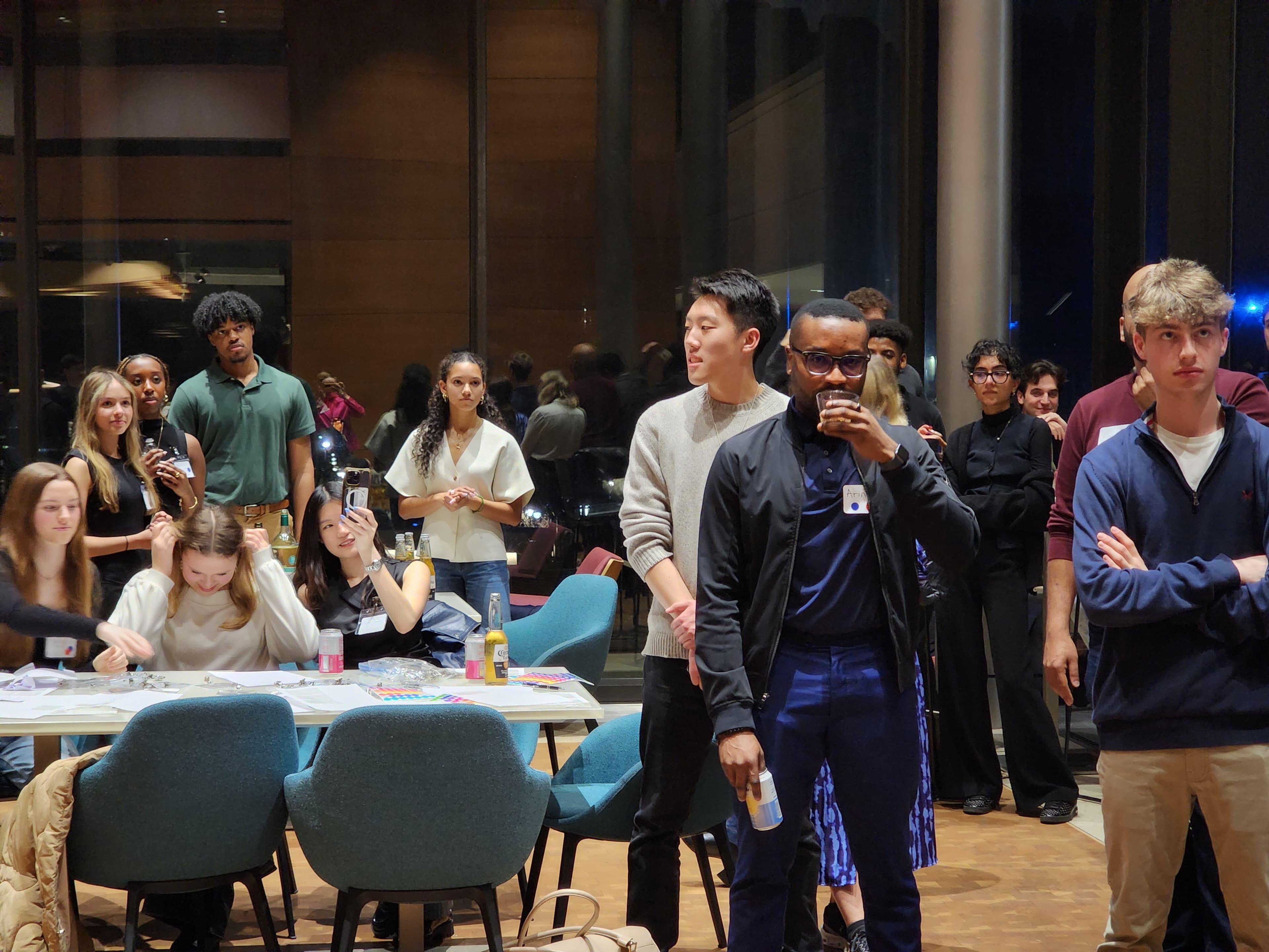 Event photo: attendees listening to remarks, some taking photos