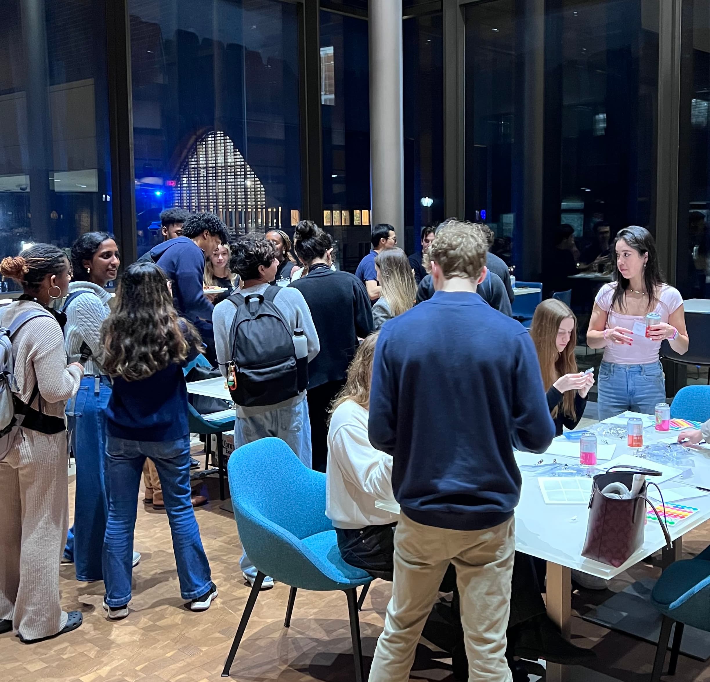 Event photo: attendees gathered around a table during the mixer